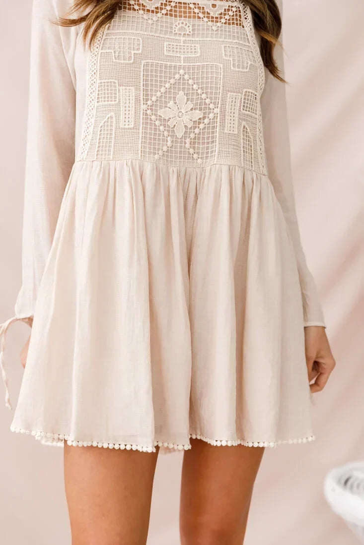 Cream crochet-yoke mini dress with long sleeves