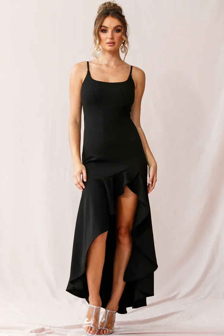 Woman in a black high-low ruffle maxi dress